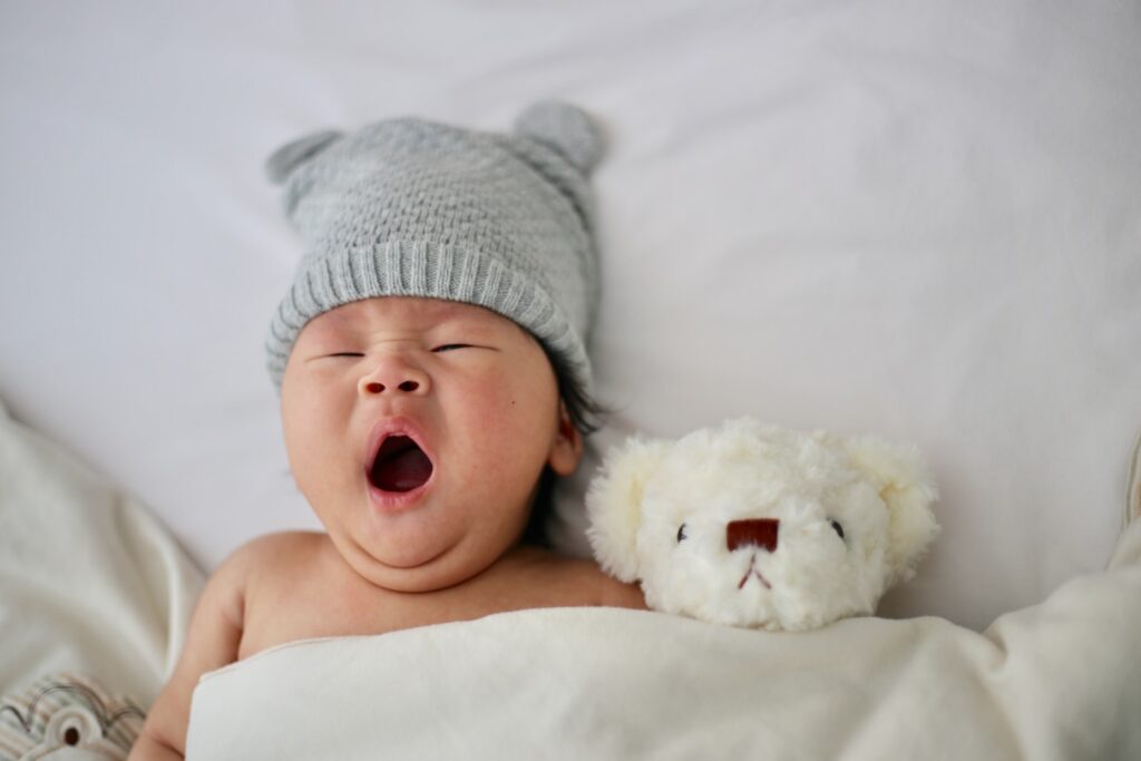 when can babies sleep with a blanket
